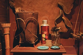 A display of traditional antiques including woven baskets and flasks