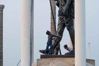 Children at the foot of a Mahatma Gandhi monument, statue, former French colony of Pondicherry or