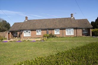 Semi-detached bungalow housing in village of Sutton, Suffolk, England, UK