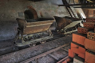 Rusty wagons with load of bricks near ring oven, kiln at brickworks, Boom, Belgium, Europe