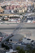 View over airport runway to Spanish town of La Linea from Gibraltar, British overseas territory in