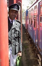 Male railway guard standing on a train Sri Lanka, Asia