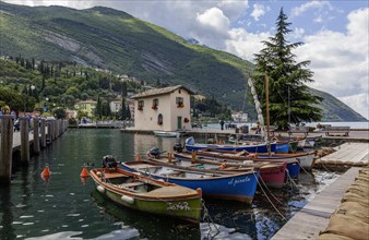 Rowing boats in the harbour, old customs house Casa del Dazio, Torbole, Lake Garda, Trentino,