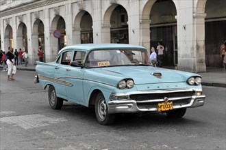 Blue vintage car from the 50s in Avenida Simon Bolivar, Calle Reina, centre of Havana, Centro