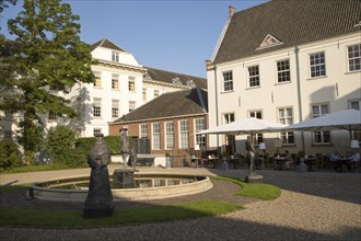 Statues sculptures in garden of historic Grand Hotel Karel V, Utrecht, Netherlands