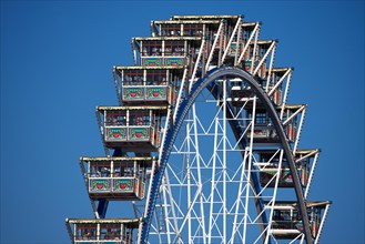 Oktoberfest, afternoon, people, visitors having fun on the Ferris wheel, Munich, Bavaria, Germany,