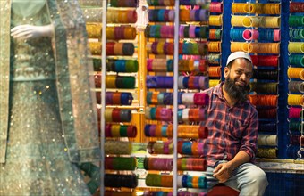 Trader with Hyderabad's famous glass hoops, bazaar, at Charminar, Hyderabad, Andhra Pradesh, India,