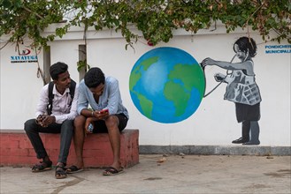 Child with globe, graffiti-painted wall, Pondicherry or Puducherry, Tamil Nadu, India, Asia