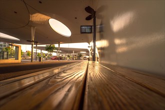 Sunset atmosphere at a bus stop from the ground perspective, bus station, Pforzheim, Germany,