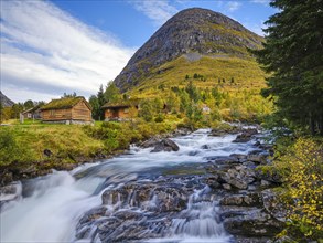 Autumn in Valldalen, cabins by a river in front of a mountain, Reinheimen National Park, More og
