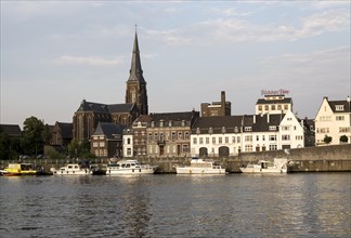 Evening light boats buildings, River Maas or Meuse, Maastricht, Limburg province, Netherlands
