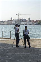 Police laser speed measurement on the island of San Giorgio Maggiore, on the waterfront of the