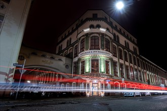 Stripes of light in front of a theatre building at night using long exposure Kollmar &