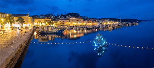 Blue hour, illuminated Christmas tree in the harbour basin, panoramic viewHarbour of Mali Losinj,