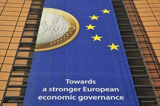Banner about the euro hanging from the Berlaymont building of the European Commission, executive