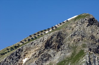 Buttresses, snow fences on mountain slope to avoid avalanches in the Alps, France, Europe