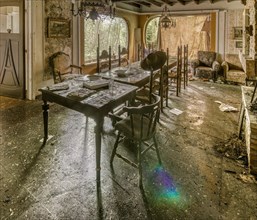 Sunlight dances on the table of an abandoned, dust-covered dining room, Maison Limmi, Lost Place,