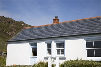 Photovoltaic roof tiles on building, Kynance Cove, Lizard Peninsula, Cornwall, England, UK