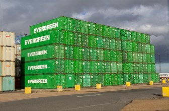 Evergreen shipping containers stacked on quayside, Port of Felixstowe, Suffolk, England, UK
