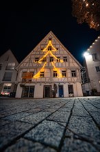 Half-timbered house with Christmas lights in the shape of a fir tree at night, Nagold, Black