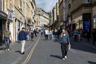 Shoppers walking in pedestrianised street in city centre, Stall Street, Bath, Somerset, England, UK