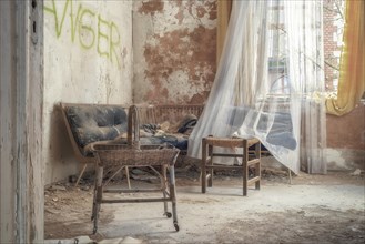 An abandoned living room with torn furniture and dust, flooded with daylight, urologist's villa Dr