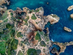 Aerial view of a picturesque coastline with cliff formations by the sea, Algarve, Lagos, Portugla,