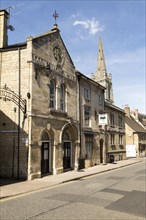 All Saints church spire and Old Fellows Hall, Church Street, Stamford, Lincolnshire, England, UK