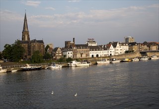 Evening light boats buildings, River Maas or Meuse, Maastricht, Limburg province, Netherlands