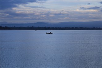 Fishing canoes in calm lake water Polonnaruwa, North Central Province, Sri Lanka, Asia