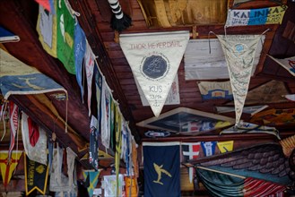 Colourful flags and pennants from Atlantic crossings hang from the ceiling of the famous Cafe