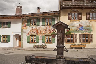 Houses, decorated with flowers, carved fountain, Lueftlmalerei, Mittenwald, Bavaria