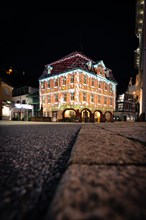 Colourful light projection on a half-timbered house at night, town hall, Nagold, Black Forest,