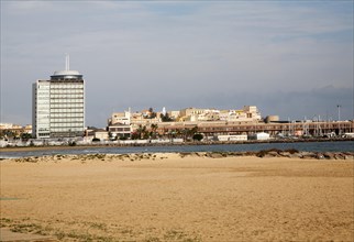 Sandy beach with view to historic walled fort of Melilla la Vieja, Melilla autonomous city state