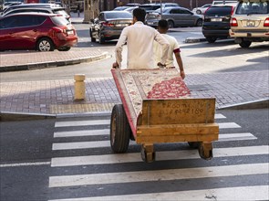 Carpet transport with handcart, Al Fahidi neighbourhood, Dubai, United Arab Emirates, Asia