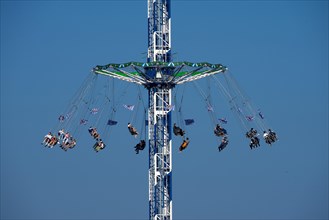Oktoberfest, afternoon, people having fun in a fairground ride, Munich, Bavaria, Germany, Europe
