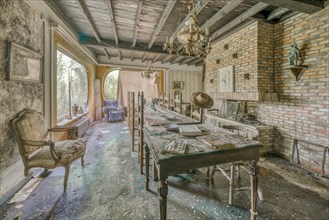 An old dining table and chairs in an abandoned room with a chandelier, Maison Limmi, Lost Place,