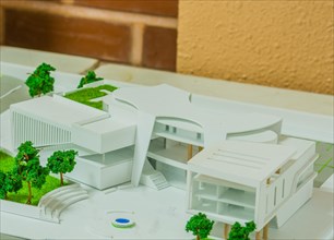 Closeup of student architectural design depicting large office building with green areas and open