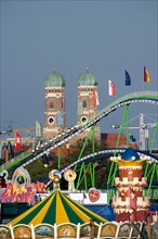Oktoberfest, afternoon with alpine railway in front of the Church of Our Lady, Munich, Bavaria,
