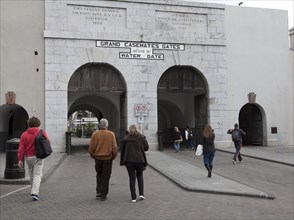 People walking at Grand Casemates gates entrance, Gibraltar, British terroritory in southern