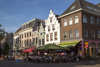 Historic buildings people sitting outside cafes central Utrecht, Netherlands