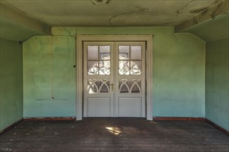 Abandoned room with peeling green wall paint and simple white doors, Schachtrupp Villa, Lost Place,