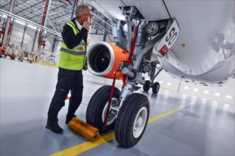 Olaf Gross, Licence Engineer at easyJet, checks the landing gear of an Airbus A320 Neo in front of