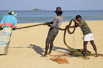 Traditional fishing hauling nets Nilavelli beach, near Trincomalee, Eastern province, Sri Lanka,