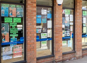 Posters and signs for training courses and job opportunities, window of Job Centre Plus,