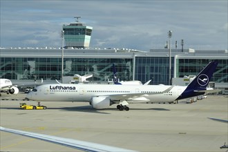 Lufthansa Airbus A 350-900 Braunschweig being towed across the apron of Terminal 2, Munich Franz