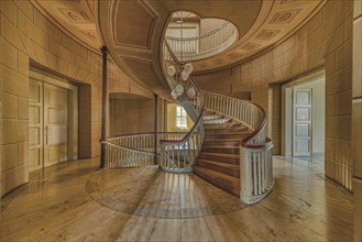 An elegant, curved wooden staircase in a room with natural lighting, Schachtrupp Villa, Lost Place,
