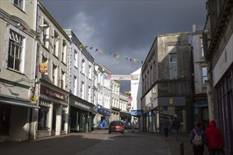 Threatening grey rain clouds over town centre street, Falmouth, Cornwall, England, United Kingdom,