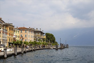 Waterfront promenade with restaurants in Gargnano, Lake Garda, Province of Brescia, Lombardy,