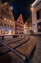 Church square with half-timbered houses and a bench at night, Nagold, Black Forest, Germany, Europe